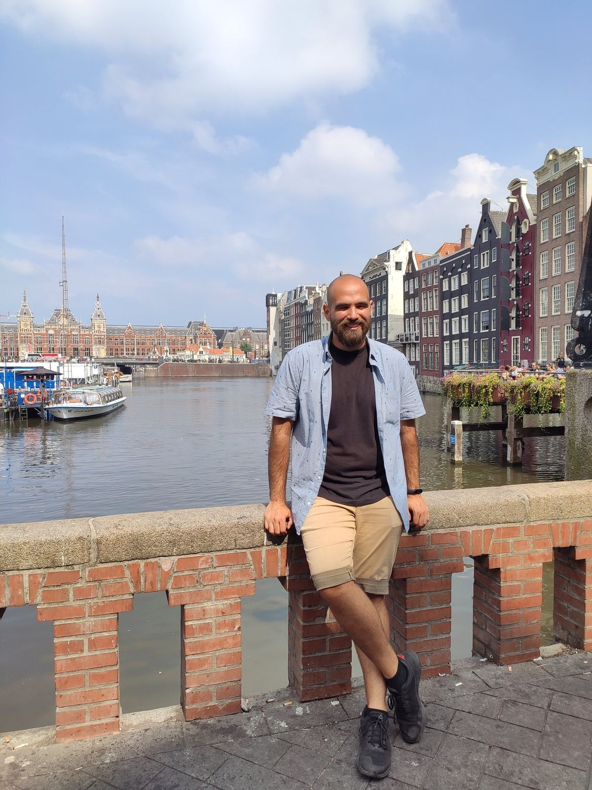 Nicolás leaning on a canal bridge