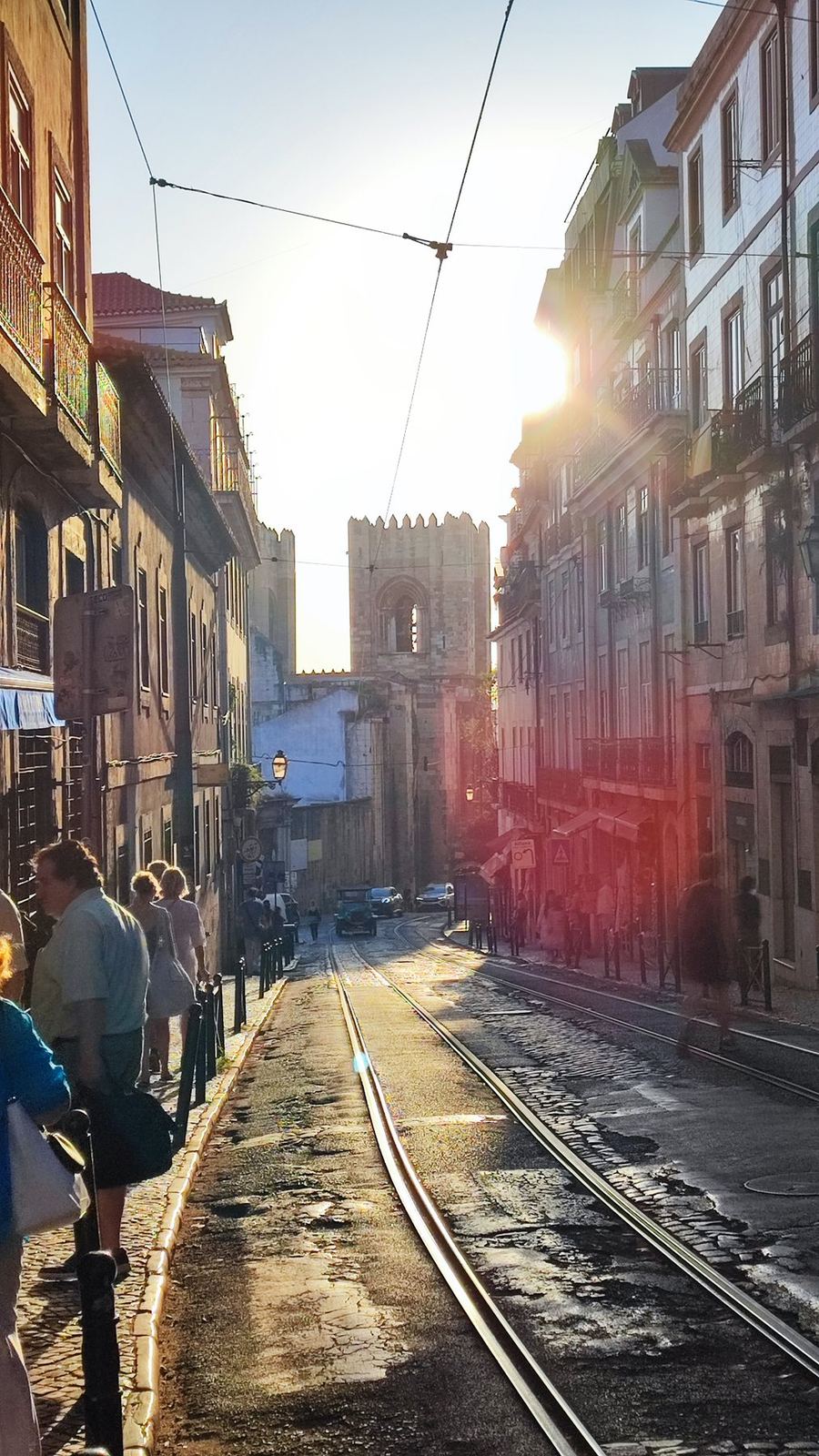 Late-afternoon light on a street with tram tracks